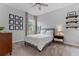 Inviting bedroom features a queen-size bed, stylish decor, and a window with a view, creating a relaxing and personalized space at 1224 Hillcrest View Loop, Apopka, FL 32703