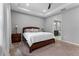 Cozy bedroom features a wooden bed frame, tray ceiling, neutral walls, and carpeted floors, creating a serene retreat at 1224 Hillcrest View Loop, Apopka, FL 32703