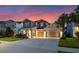 Charming two-story home featuring a manicured lawn, inviting front porch, and a spacious three-car garage at 1224 Hillcrest View Loop, Apopka, FL 32703