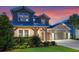 Charming two-story home with a well-manicured lawn and inviting front porch at 1224 Hillcrest View Loop, Apopka, FL 32703