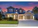 Charming two-story home with a three-car garage, well-maintained landscaping, and a welcoming front porch at 1224 Hillcrest View Loop, Apopka, FL 32703