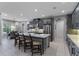 Modern, spacious kitchen with stainless steel appliances, gray cabinetry and a large center island with bar stool seating at 1224 Hillcrest View Loop, Apopka, FL 32703