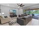 Comfortable living area with views to a screened patio and pool area, perfect for relaxation at 1224 Hillcrest View Loop, Apopka, FL 32703