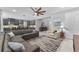Bright, open-concept living area featuring tile flooring, modern furnishings and views to the kitchen at 1224 Hillcrest View Loop, Apopka, FL 32703