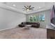 Spacious living room with a large sofa and a beautiful view from the windows at 1224 Hillcrest View Loop, Apopka, FL 32703