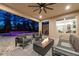 Covered patio with outdoor kitchen, fireplace and comfortable seating with lighting, perfect for evenings at 1224 Hillcrest View Loop, Apopka, FL 32703
