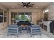 Relaxing covered patio with outdoor kitchen, fire pit, and cozy furniture at 1224 Hillcrest View Loop, Apopka, FL 32703