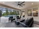 Serene screened-in patio with fire pit, comfortable seating, and scenic pool view at 1224 Hillcrest View Loop, Apopka, FL 32703