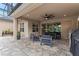 Charming covered patio featuring an outdoor kitchen, and comfortable seating at 1224 Hillcrest View Loop, Apopka, FL 32703