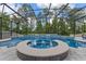 Screened-in pool and spa, surrounded by lush landscaping and views of the serene backyard at 1224 Hillcrest View Loop, Apopka, FL 32703