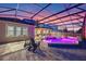 Backyard pool and spa area with colored lighting, screened enclosure, and relaxing lounge chairs at 1224 Hillcrest View Loop, Apopka, FL 32703