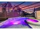 Beautiful screened pool and spa with multicolor LED lighting creates a relaxing outdoor retreat at 1224 Hillcrest View Loop, Apopka, FL 32703
