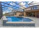 Spacious backyard with a large screened-in pool, spa, and seating area at 1224 Hillcrest View Loop, Apopka, FL 32703