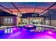 Spacious backyard with a screened-in pool, hot tub, outdoor seating, and a kitchen area at 1224 Hillcrest View Loop, Apopka, FL 32703