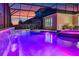 Relaxing poolside view showcasing waterfall feature, hot tub and screened lanai at 1224 Hillcrest View Loop, Apopka, FL 32703