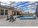 Stunning backyard pool with spa, screened enclosure, and lounge chairs at 1224 Hillcrest View Loop, Apopka, FL 32703