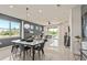 Modern dining space featuring a marble table, stylish chairs, and views to outdoor living area at 13521 Pearl Beach St, Winter Garden, FL 34787