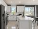 Bright kitchen with white cabinets, a center island, and black appliances, offering ample countertop space at 13521 Pearl Beach St, Winter Garden, FL 34787