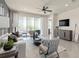 Inviting living room with modern decor, plush seating, and sliding glass doors at 13521 Pearl Beach St, Winter Garden, FL 34787