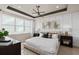 Serene main bedroom featuring large window, contemporary lighting, and modern decor at 13521 Pearl Beach St, Winter Garden, FL 34787