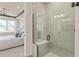 Modern bathroom featuring a glass-enclosed shower with a built-in seat, complemented by neutral tones at 13533 Pearl Beach St, Winter Garden, FL 34787