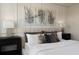 Modern bedroom featuring a neutral color palette and decorative wall art above the upholstered headboard at 13533 Pearl Beach St, Winter Garden, FL 34787