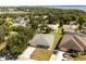 Aerial view of the neighborhood showcasing a single-Gathering home with lake view in the background at 13848 Vista Del Lago Blvd, Clermont, FL 34711