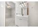 Well-lit bathroom features a modern vanity with a built-in sink and ample storage at 13848 Vista Del Lago Blvd, Clermont, FL 34711