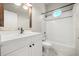 Bathroom with a tub, white vanity, and a round decorative window at 13848 Vista Del Lago Blvd, Clermont, FL 34711