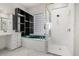 Stylish bathroom showcasing a built-in tub, glass-enclosed shower, and unique tile work for a modern touch at 13848 Vista Del Lago Blvd, Clermont, FL 34711