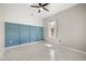Modern bedroom with custom blue accent wall and tile flooring at 13848 Vista Del Lago Blvd, Clermont, FL 34711