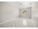 Bright bedroom featuring tile flooring and a large window with natural light at 13848 Vista Del Lago Blvd, Clermont, FL 34711