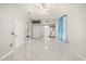 Bright bedroom with white tile flooring and a sliding glass door to an outdoor patio space at 13848 Vista Del Lago Blvd, Clermont, FL 34711