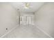 Spacious bedroom boasts tiled floors, ceiling fan, and closet storage at 13848 Vista Del Lago Blvd, Clermont, FL 34711