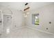 Open dining area with white tile floors and a modern light fixture near a bright window at 13848 Vista Del Lago Blvd, Clermont, FL 34711