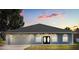 Charming single-story home showcasing a well-maintained lawn, two car garage and inviting arched windows at 13848 Vista Del Lago Blvd, Clermont, FL 34711