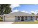 Charming single-story home showcasing a well-maintained lawn, two car garage and inviting arched windows at 13848 Vista Del Lago Blvd, Clermont, FL 34711