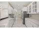 Bright kitchen with white cabinets, tile backsplash, stainless steel appliances, and white tile floors at 13848 Vista Del Lago Blvd, Clermont, FL 34711
