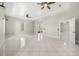 Bright living room boasting tile flooring, ceiling fan, and natural light at 13848 Vista Del Lago Blvd, Clermont, FL 34711