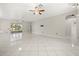 Bright living space showcasing ceramic tile floors, ceiling fan, with views of the lanai and backyard at 13848 Vista Del Lago Blvd, Clermont, FL 34711