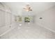 Inviting living space with tile flooring, a ceiling fan, and a seamless connection to the outdoors and a breakfast bar at 13848 Vista Del Lago Blvd, Clermont, FL 34711