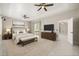 Modern primary bedroom with large bed, TV, and access to the backyard at 13848 Vista Del Lago Blvd, Clermont, FL 34711