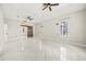 Large main bedroom featuring an open floor plan, tile floors, modern lighting, and neutral walls at 13848 Vista Del Lago Blvd, Clermont, FL 34711