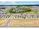A wide shot showcases a home near community spaces, landscaping and a picturesque pond at 15133 Summer Harvest St, Winter Garden, FL 34787