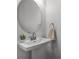 Stylish half-bathroom with a pedestal sink and modern fixtures at 15133 Summer Harvest St, Winter Garden, FL 34787