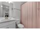 Bathroom with sink and toilet featuring white finishes and pink shower curtain at 15133 Summer Harvest St, Winter Garden, FL 34787