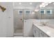 Bathroom featuring a shower, white vanity with quartz counters, and wood-look floors at 15133 Summer Harvest St, Winter Garden, FL 34787