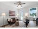 Bedroom or office with brown leather couch, desk, and balcony access at 15133 Summer Harvest St, Winter Garden, FL 34787