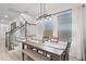 Dining room features a modern table with bench seating, pendant lighting and large windows at 15133 Summer Harvest St, Winter Garden, FL 34787