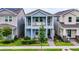 Charming two-story home with blue exterior, balcony, well-manicured lawn, and inviting curb appeal at 15133 Summer Harvest St, Winter Garden, FL 34787